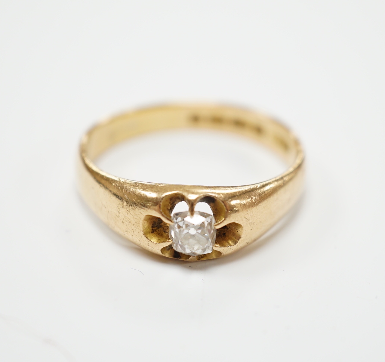 A George V 18ct gold and claw set solitaire diamond ring, size W, gross weight 7.2 grams.